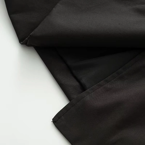 Detail of black twill fabric texture and reinforced double-stitching on the jacket trim