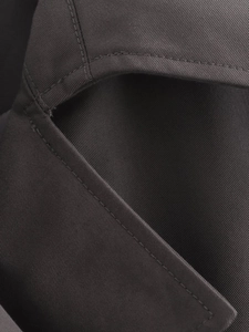 Macro shot of dark taupe twill fabric with precision stitching on short trench coat