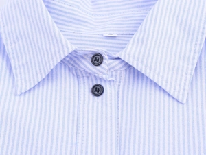 Close-up of a blue and white striped poplin shirt with a double-button collar detail
