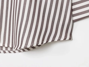 Detail of the high-quality stitching on striped linen blend shirt hem for women