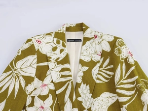 Close-up of linen-blend blazer collar showing vintage olive green floral and leaf prints