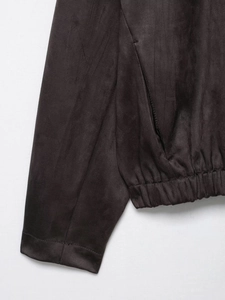 Detailed view of dark brown faux suede jacket featuring elastic hem and ribbed cuffs