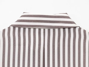 Detail of the linen blend shirt collar featuring contrasting vertical and horizontal stripes