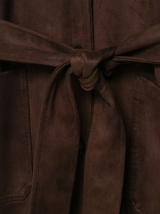 Gros plan détaillé d'une veste en daim marron foncé avec ceinture à la taille et boutons