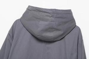 Detailed view of the grey hooded jacket showing back stitching and high-quality fabric texture