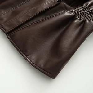 Detail of dark brown faux leather jacket with fine stitching and elasticated waist detail