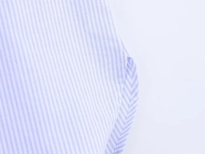 Detailed macro view of the side gusset and fine blue striped poplin fabric texture