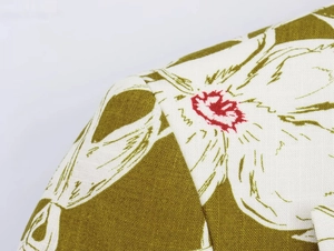 Detailed close-up of linen blend floral fabric with white petals and red accents