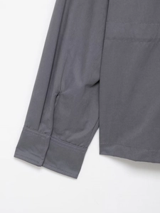 Close-up of dark grey hooded jacket sleeve featuring clean double-needle stitching detail
