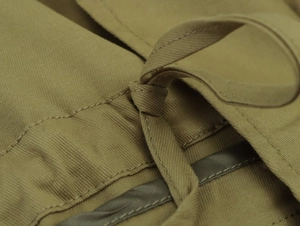 Close-up of khaki parka jacket featuring adjustable drawstrings and durable twill fabric