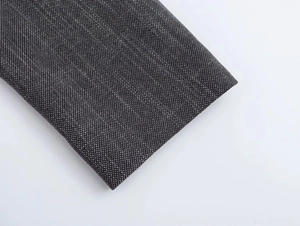 Close-up of dark grey textured fabric weave detail for women's shoulder padded blazer
