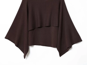 Close-up of soft dark brown knit fabric with a modern layered hem and batwing sleeve design