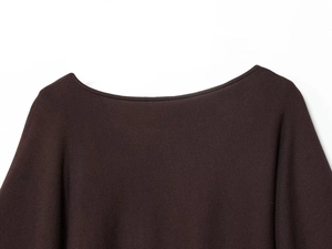 Detailed view of dark brown knitted fabric texture and boat neck seam on women top