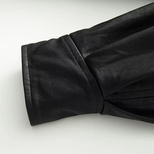 Detail of premium black faux leather jacket sleeve with neat stitching and fine grain texture