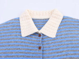 Detailed close-up of striped knit cardigan collar with cable knit and brown buttons