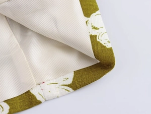 Detail of linen blend floral blazer with olive green outer fabric and smooth cream lining