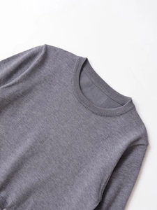 Detail of grey knitwear ribbed neckline and fabric texture with button decor