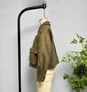 Detail of army green faux suede bomber jacket showing textured collar and utility pocket