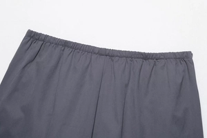 Close-up of elastic waistband on dark grey cargo skirt with clean stitching
