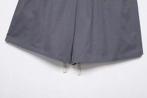 Detailed close-up of dark grey cargo shorts featuring double-stitched hem and cotton drawstrings