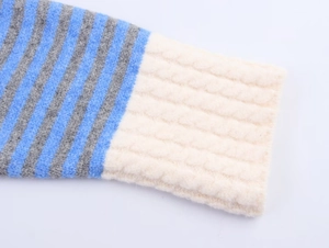Close-up of color-block striped knit sleeves with warm ribbed cuffs on a cozy cardigan