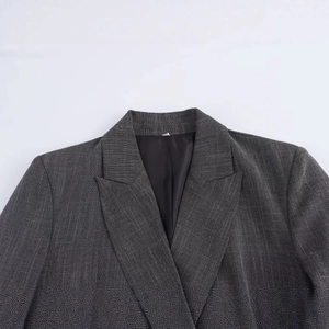 Dark grey tweed blazer for women featuring classic notch lapels and padded shoulders