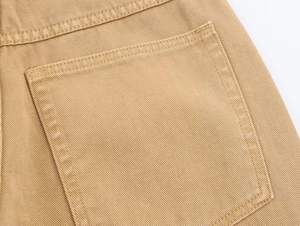 Detail view of khaki loose straight jeans showing back pocket and double-needle stitching