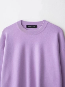 Close-up of ribbed crew neck and shoulder detail on a lavender knit sweater