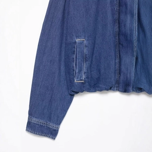 Deep blue denim jacket with twill texture and detailed stitching on the cuff and pocket