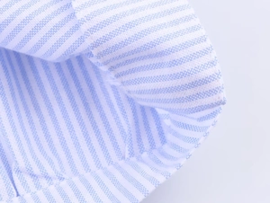 Macro shot of blue and white striped fabric texture with detailed stitching and soft weave