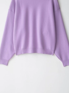 Detail of lavender ribbed knit sweater showing soft texture and ribbed hem sleeve finish