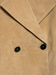 Detail of camel faux suede jacket featuring notched lapels and black buttons