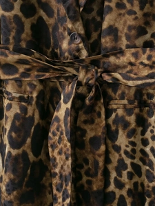 Close-up of leopard print blazer with silk texture, lapel detail and waist tie