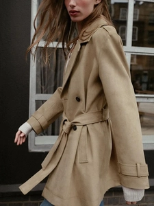Detail shot of khaki suede-effect trench coat featuring double-breasted belt and cuffs
