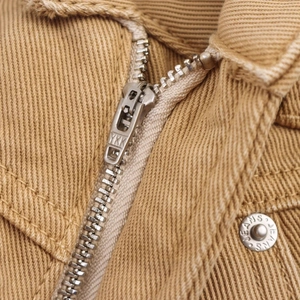 Close-up of heavy cotton twill jacket with YKK zipper and engraved metal buttons