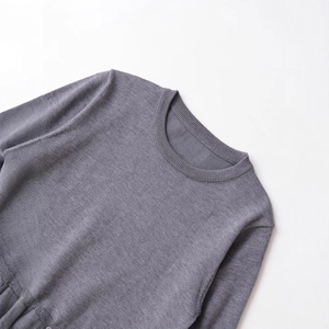 Elegant grey knit sweater with round neckline and ribbed details on white background
