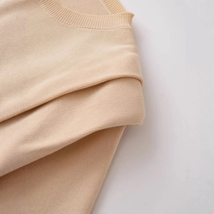 Chic beige short sleeve knit top with padded shoulders and a classic crew neck