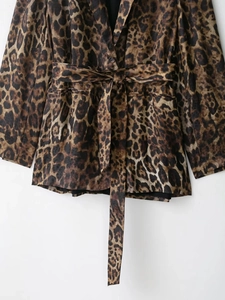 Detailed view of women's leopard print blazer with notched lapel and matching waist belt