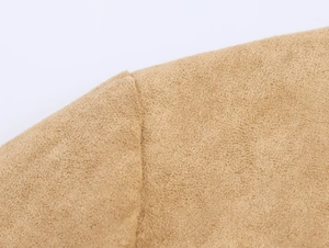 Detailed macro view of camel suede fabric showing precise stitching and soft velvet texture