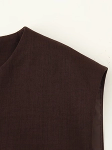 Detail shot of a coffee brown vest showing round neck and premium twill fabric texture