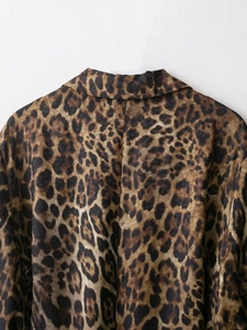 Detail of animal print blazer showing the satin texture and classic leopard pattern