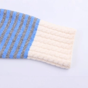 Close-up of ribbed cuffs on a blue and grey striped knit cardigan with premium texture