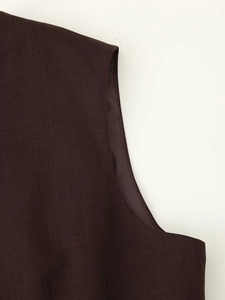 Detail shot of clean inner stitching and smooth satin lining on dark brown suit vest