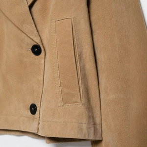 Short tan faux suede cropped jacket featuring black buttons and large patch pockets