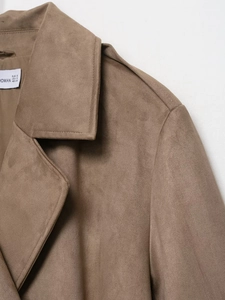 Detail shot of brown faux suede coat collar with stitched seams and white size label