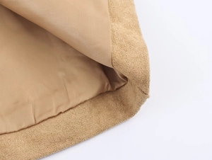 Close-up of khaki suede coat fabric showing premium texture and neat interior lining