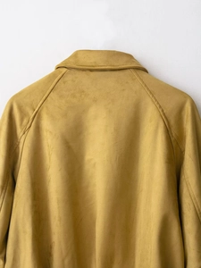 Detailed back view of mustard suede bomber jacket neckline and raglan sleeve seams
