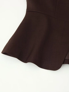 Detailed macro view of dark brown twill fabric with elegant ruffled hemline design