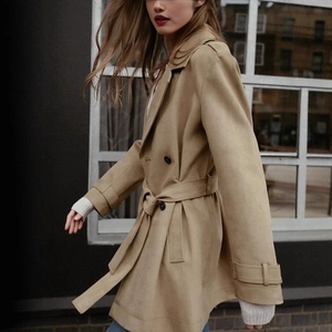 Chic khaki double-breasted trench coat with waist belt and adjustable cuffs in street style