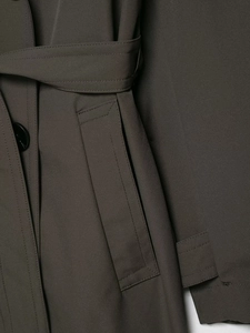 Detail view of water-resistant trench coat with adjustable waist belt and pocket flap